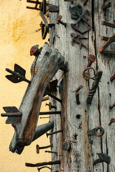 stock image nails and various iron objects stuck in the old wooden beam