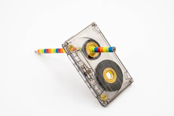 Stock image Old music magnetic cassette and wooden pencil on white background