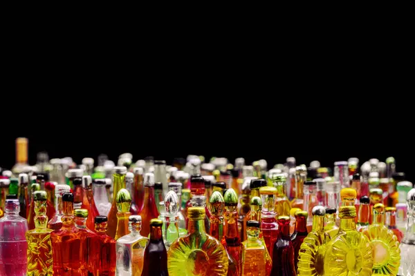 stock image various miniature bottles of alcohol without labels with black bacground