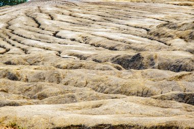 dried mud at Muddy Vulcanos located in Buzau County, Romania, a National Landmark, Gas bubbles coming out a mud volcano. Paclele mici and Paclele Mari clipart