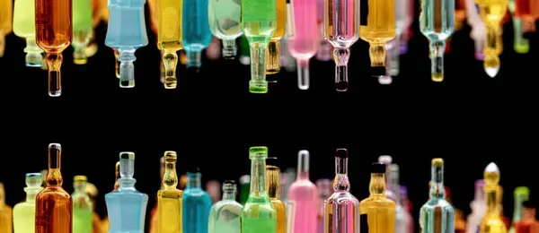 stock image miniature resin drink bottles on dark background