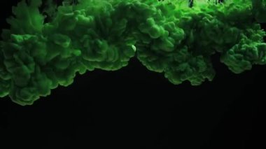 Powerful explosion of green ink splash in water