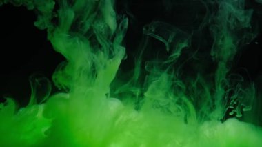 Green ink in water form an abstract smoke pattern