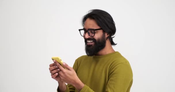Bearded Young Man Laughing Cheerfully While Scrolling Social Media Smartphone — Stock Video