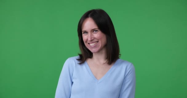 Shy Caucasian Woman Stands Green Screen Background Smiling Covering Her — Stock Video