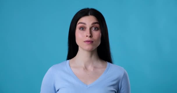 Close Portrait Caucasian Woman Standing Blue Background She Looks Directly — Stock Video