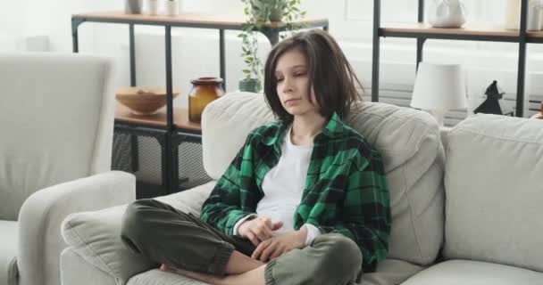 Young Caucasian Boy Checkered Shirt Sits Sofa Reflecting His Deep — Stock Video