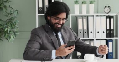 Yavaş çekimde, Hintli bir işadamı ofisinde oturmuş sıcak bir içeceği içerken mesaj atıyor. Aniden, onu sevinçten kahkahalara boğan komik bir mesaj alır..