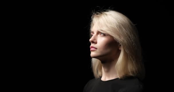 Caucasian Woman Stands Black Background Her Eyes Fixed Upward Light — Stock Video
