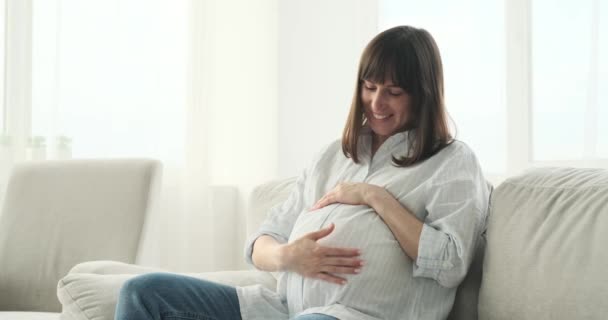 Vacker Gravid Kvinna Finner Tröst Soffan Med Ett Strålande Leende — Stockvideo