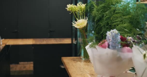 Άνδρας Ανθοπώλης Τοποθετεί Απαλά Ένα Ζωντανό Μπουκέτο Λουλούδια Στον Πάγκο — Αρχείο Βίντεο