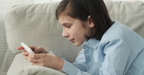 Een Schoolgaande Jongen Liggend Bank Ondergedompeld Zijn Telefoon Gaming Ervaring — Stockvideo