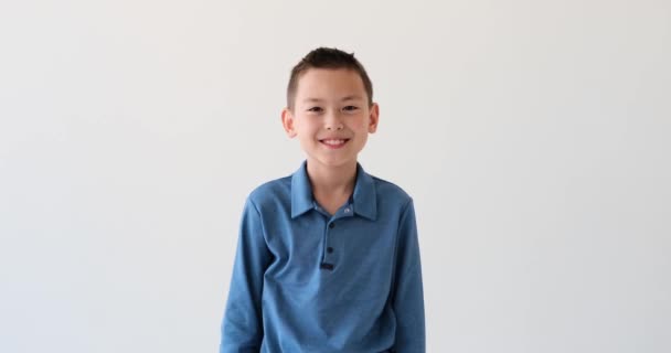 Asian Schoolboy Presents Confident Engaging Portrait White Backdrop Crossed Arms — Stock Video