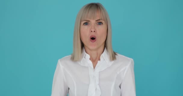 Shocked Woman Shown Covering Her Mouth Surprise Serene Blue Background — Stock Video