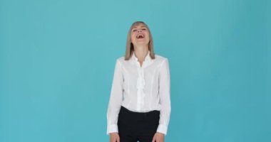 Güzel bir kadının mutlu bir şekilde kahkahalarla güldüğü gösteriliyor. Çekici gülüşü ve bulaşıcı gülüşü sıcaklık ve mutluluk saçıyor. Mavi arka plan biraz sükunet katıyor..