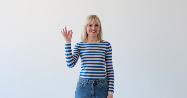 Joyful Woman Seen Clean White Backdrop Making Gesture Her Hand — Stock Video