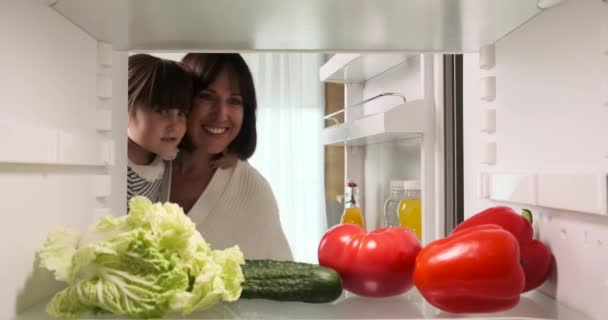 Mother Holding Her Daughter Her Arms Opens Refrigerator Selects Groceries — Stock Video