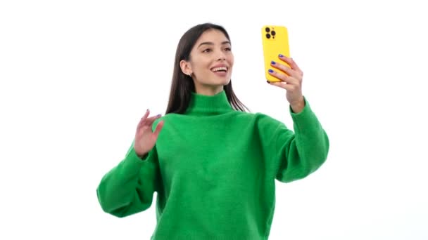 女人在一个干净的白色背景下使用电话进行视频通话 这张图片抓住了便利虚拟通信的技术的本质 — 图库视频影像