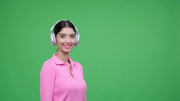 Γυναίκα Φορώντας Ακουστικά Ατενίζει Προς Δεξιά Συλλαμβάνοντας Μια Στιγμή Περιέργειας — Αρχείο Βίντεο
