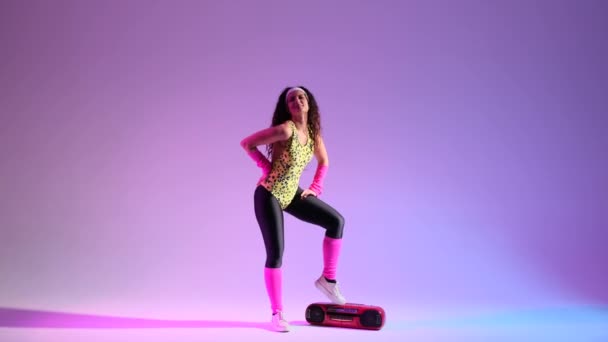 Curly 80S Woman Grooves Vibrant Retro Attire Purple Backdrop Dancing — Stock Video