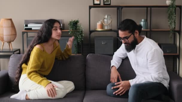 怒っている 不幸なインドのカップルはリビングルームのソファーで喧嘩して叫びます 家族の危機と紛争 悪いカップル関係 — ストック動画