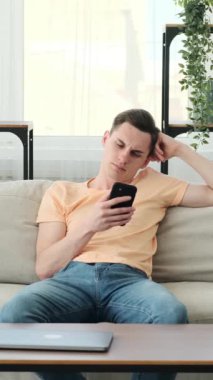 Sıradan giyinen bir adam, kendini telefonuna dalmışken bir esnemede bulur. Gözlerindeki yorgunluk ve şüphesiz esneme hissi monoton bir anın özünü yakalıyor..