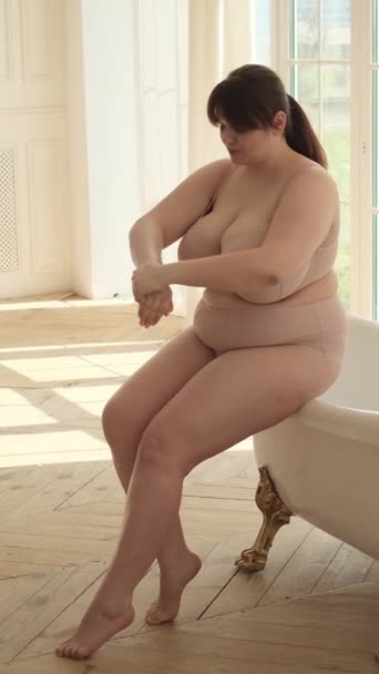 Una Mujer Caucásica Talla Grande Sentada Borde Una Bañera Masajeando — Vídeos de Stock