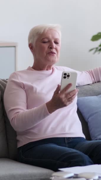 成熟的高加索快乐女人在家里挥手 用智能手机进行在线视频通话和问候 虚拟对话和交流 垂直录像 — 图库视频影像