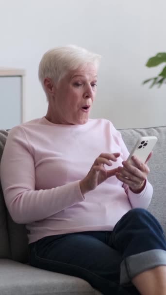 Elderly Friendly Caucasian Woman Using Cellphone Receiving Good News Online — Stock Video