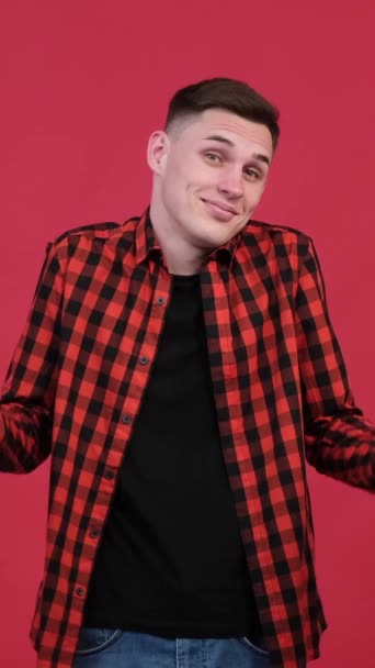 Positive Caucasian Young Man Spreading Arms Shrug Shoulder Red Background — Stock Video