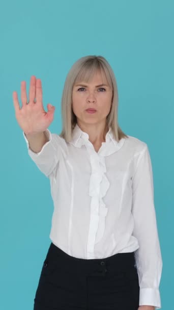 Upset Caucasian Female Employee Showing Stop Sign Palm Blue Background — Stok video