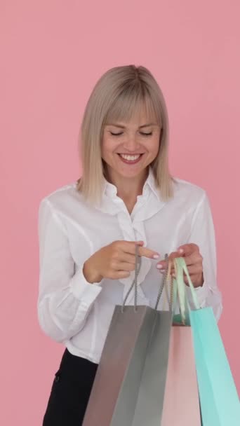 Portrait Happy Caucasian Woman Holding Shopping Bags Pink Background Celebrating — Stock Video