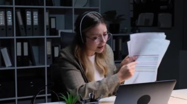 Ofisteki dizüstü bilgisayarla online toplantı sırasında iş arkadaşlarına bağırıp çağıran, evrak işleriyle uğraşan agresif Kafkas genç iş kadını..