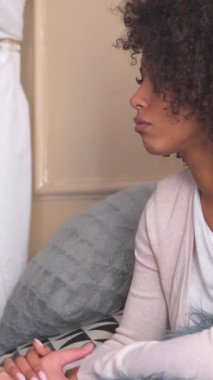 Neşeli karı koca, keyifli bir sohbet ederken yatak odasında yakın bir eğlence paylaşıyorlar. Dikey video.