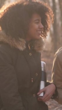 Tatilde birlikte gezen aile çifti. Açık havada güzel doğal ortamlarda ışık aktivitesi ve doğada tamamen rahatlamayı birleştiriyorlar. Dikey video.