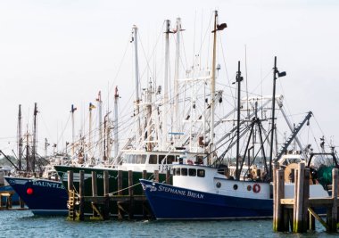 Narragansett, Rhode Island, USA - 27 June 2021: Commercial fishing boats docked backed in to their spots in a marina in Narragansett Rhode Island.
