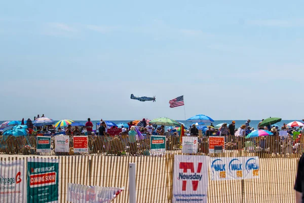 stock image Jones Beach, New York, USA - 26 May 2023: P-51 Mustang fighter jet fron the American airpower museum warbirds flying low over the atlantic ocean at the jones beach air show.