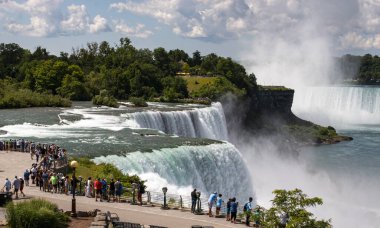 Niagara, New York, USA - 1 August 2023: A group of people standing at the base of the waterfalls in Niagara Falls New York State Park