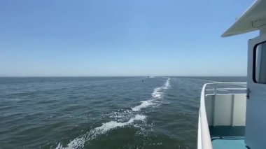 İnsanları Fire Island 'a nakleden yolcu feribotu başka bir feribotu geçerek Great South Bay Long Island' daki insanları evlerine getiriyor..