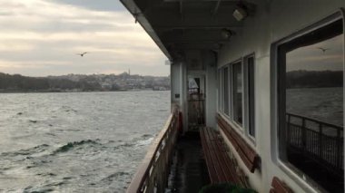 İstanbul 'da feribottan gelen dalgalı deniz camlara yansıyor