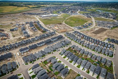 Saskatoon 'daki Rosewood mahallesinin yükseltilmiş görüntüsü, Saskatchewans' ın sakin doğal tuvaliyle iç içe geçmiş kentsel tasarım bir duvar halısı sunuyor..