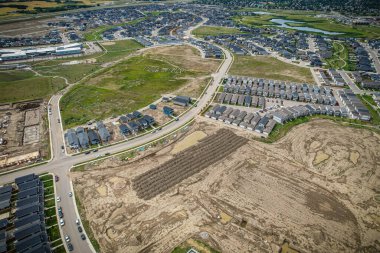 Saskatoon 'daki Rosewood mahallesinin yükseltilmiş görüntüsü, Saskatchewans' ın sakin doğal tuvaliyle iç içe geçmiş kentsel tasarım bir duvar halısı sunuyor..