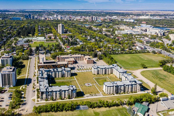 Ascend above Varsity View, the Saskatoon neighborhood celebrated for its proximity to university life. The drone image showcases a mix of residential areas, academic buildings, and lush parklands.
