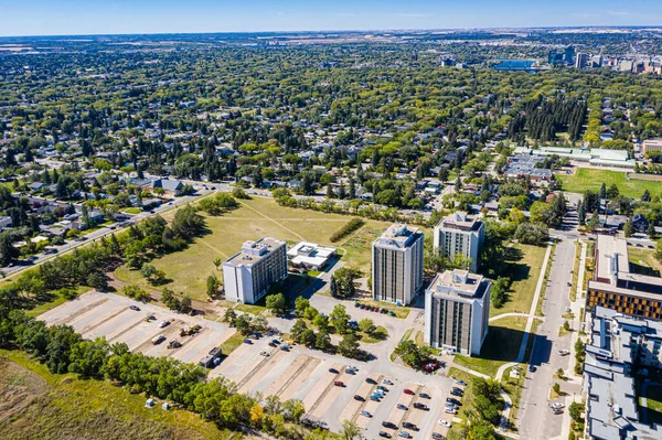 Ascend above Varsity View, the Saskatoon neighborhood celebrated for its proximity to university life. The drone image showcases a mix of residential areas, academic buildings, and lush parklands.