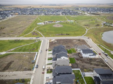 Saskatchewan, Saskatchewan 'daki Brighton banliyö mahallesini gösteren yüksek çözünürlüklü bir hava aracı fotoğrafı. Görüntü, açık bir günde konut, yeşil alanlar, sokaklar ve yakındaki konforların yerleşim yerlerini yakalıyor.