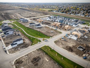 Saskatchewan, Saskatchewan 'daki Brighton banliyö mahallesini gösteren yüksek çözünürlüklü bir hava aracı fotoğrafı. Görüntü, açık bir günde konut, yeşil alanlar, sokaklar ve yakındaki konforların yerleşim yerlerini yakalıyor.