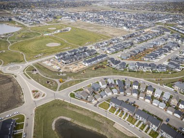 Saskatchewan, Saskatchewan 'daki Brighton banliyö mahallesini gösteren yüksek çözünürlüklü bir hava aracı fotoğrafı. Görüntü, açık bir günde konut, yeşil alanlar, sokaklar ve yakındaki konforların yerleşim yerlerini yakalıyor.