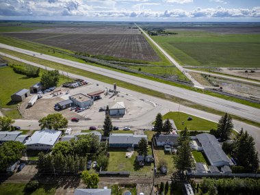 An aerial drone photo of Delisle, Saskatchewan, showcasing residential areas, tree-lined streets, parks, and community amenities in this small town surrounded by scenic prairie landscape. clipart