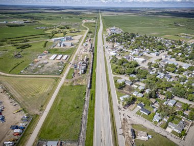 An aerial drone photo of Delisle, Saskatchewan, showcasing residential areas, tree-lined streets, parks, and community amenities in this small town surrounded by scenic prairie landscape. clipart