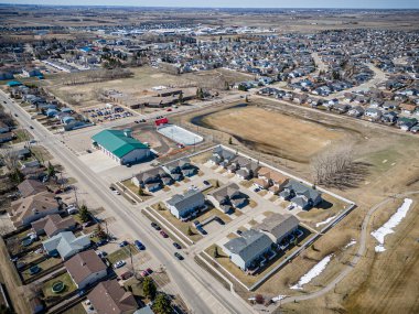 A high-resolution aerial drone photo of Warman, Saskatchewan, featuring residential areas, parks, open green spaces, and community amenities in this thriving suburban city. clipart